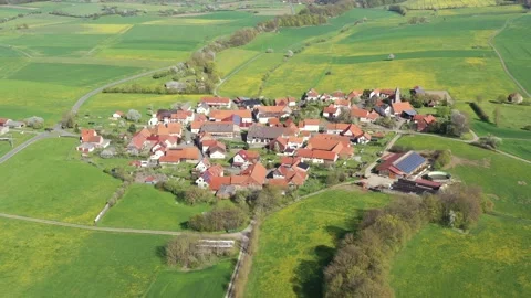 The village of Archfeld between the fields in North Hesse Stock Footage 240646860