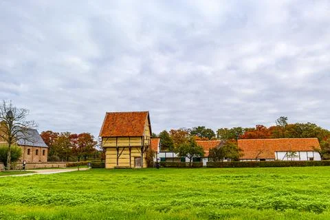 Village landscape with a plot of green grass with an old farmhouse 写真素材