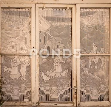 Village life in lace curtain windows Stock Photos