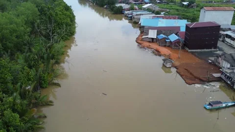 The village is located on the edge of the river, the river looks dirty Stock Footage 278570641