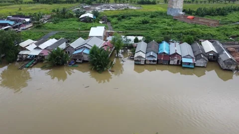 The village is located on the edge of the river, the river looks dirty Stock Footage 278571434