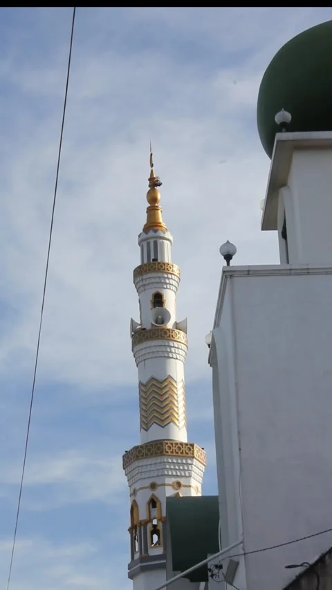 Village mosque tower isolated on cloudy blue sky background Video stock 307353785