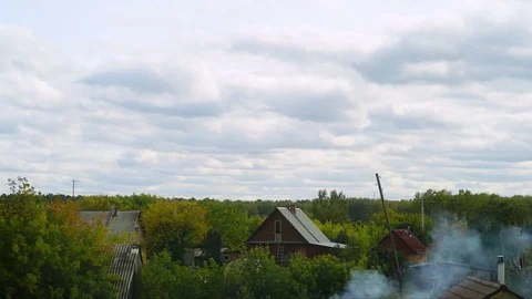 Village scape. Cloud timelaps. cloud above wooden cottage and greenery. Stock Footage 81500202