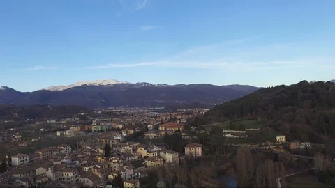 Village with snowy Alpine mountains as a background in the Italy Stock Footage