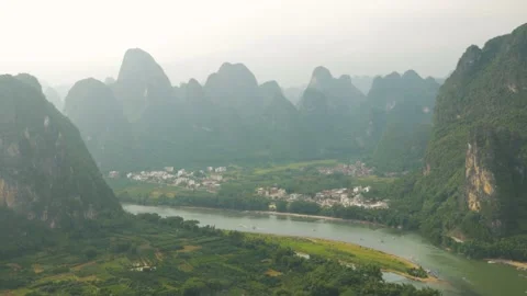 Village surrounded by sugar loaf with rivers, in Yangshuo, China Stock Footage 232184732