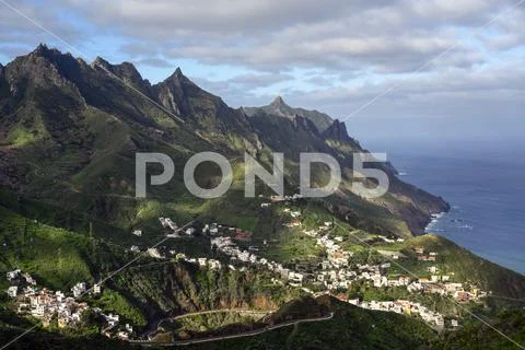 Village of Taganana on coast of Tenerife, Spain with rugged mountains of Anaga b Stock Photos