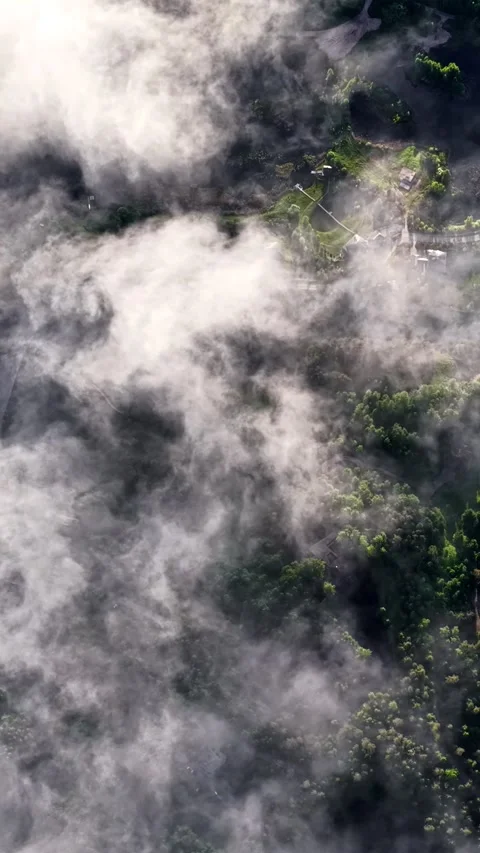 Village visible through dramatic rolling clouds Stock Footage 336755338