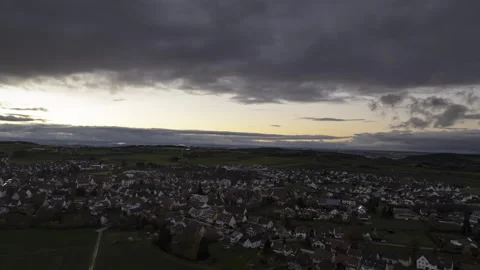 Village while dawn under dark clouds aerial time lapse Stock Footage 221840082