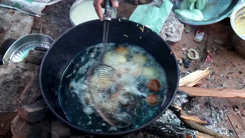 A villager makes local snacks Stock Footage 80991339
