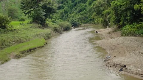 The villagers are doing their laundry in the river Stock Footage 154190086