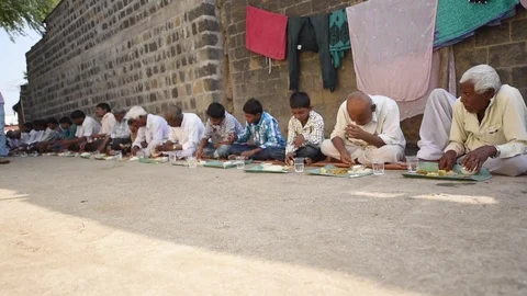 Villagers are having common cooked and served food Stock Footage 77193107