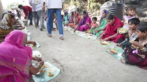 Villagers are having common cooked and served food Stock Footage 77193150