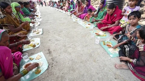 Villagers are having common cooked and served food Stock Footage 77193163
