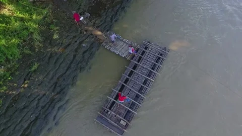 Villagers crossing the river using bamboo raft as a traditional transportati Stock Footage 158718703