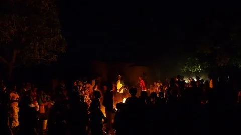 Villagers dancing around campfire Video stock 80620388