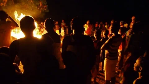 Villagers partying around campfire Stock Footage 80622672