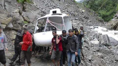 Villagers transporting crashed Chopper from mountains to city . Stock Footage 145539527