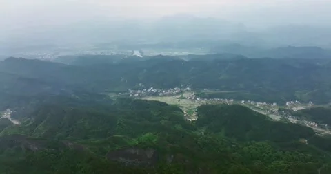 The villages in the distance loomed, Around  Danxia Landform, in Cloudy Day Stock Footage 218581253