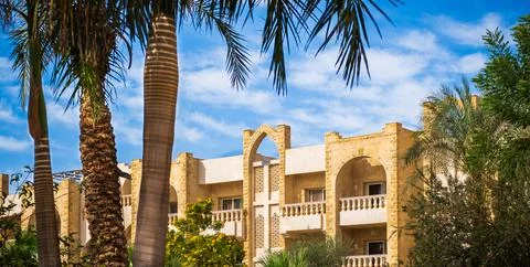 Villas compound development in a bright sunny day with white clouds in the bl Stock Photos
