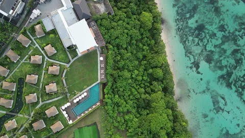 Villas, Trees on cliff hugging the ocean in Bali Asia Stock Footage 312238247
