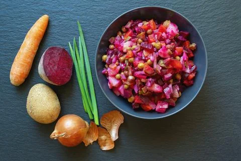 Vinaigrette, beetroot based vegetable salad  in plate with ingredients Stock Photos