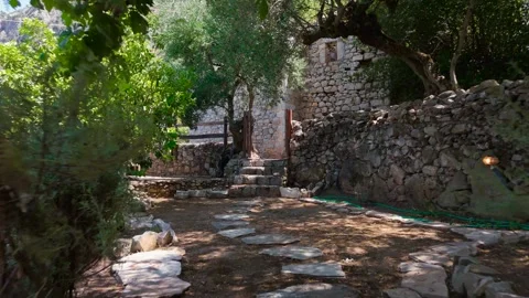 Vine-Covered Pergola and Rustic Stone Courtyard Stock Footage 343916470
