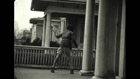 Vintage 16mm film 1933 Pennsylvania girls roller skate porch Stock Footage