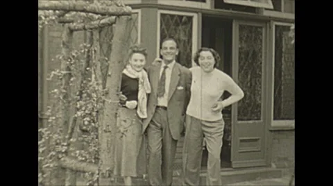 Vintage 16mm film, 1953, UK, three happy people, smiling hamming it up Stock Footage