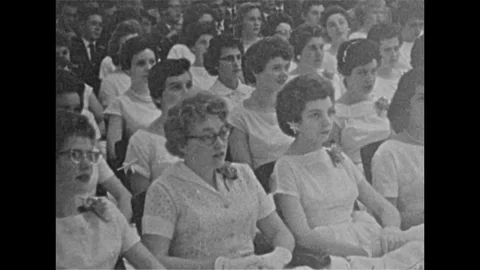 Vintage 16mm film, 1957 Canada, grad ceremony, audience, students on stage Stock Footage