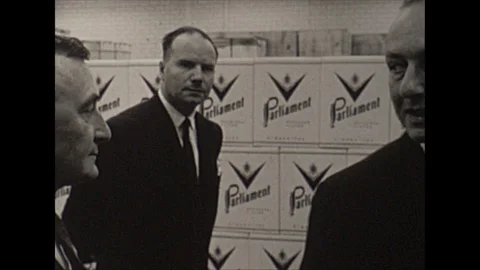 Vintage 16mm film, 1963 Canada, men walk cigarette factory  Stock Footage