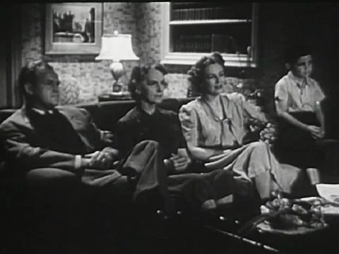 Vintage 1940s family watching Television Stock Footage