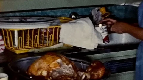 Vintage 1960s Opening can while preparing Christmas dinner. 8mm home video. Stock Footage 239497219