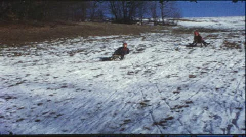 Vintage 8mm film: Children on sledge, 1960s Stock Footage