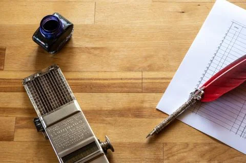 Vintage adding machine on ledger purchases journal page with feather quill an Stock Photos