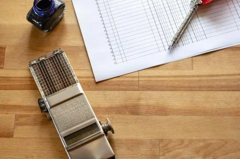 Vintage adding machine on ledger purchases journal page with feather quill an Stock Photos