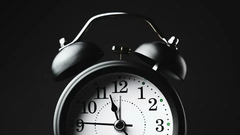 Vintage alarm clock. Clock face on black background. Stockbeeldmateriaal 328462560