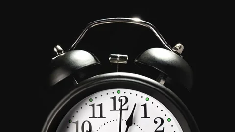 Vintage alarm clock. Clock face on black background. Stock Footage 331241690