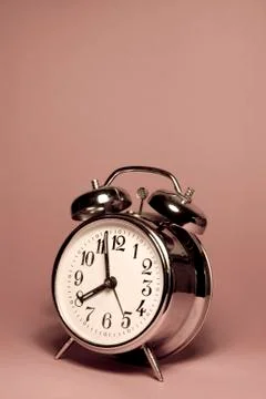 Vintage alarm clock on a solid color background Stock Photos