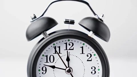 Vintage alarm clock on white background. Old fashioned alarm clock with bells. Stock Footage 330768714