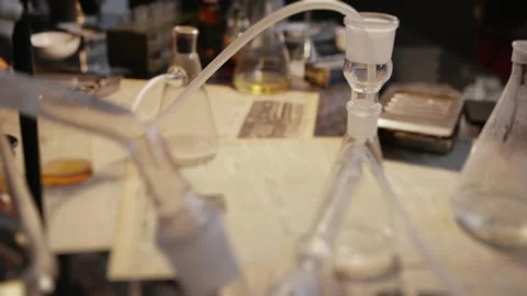 Vintage alchemy laboratory equipment on table Video stock 321826739