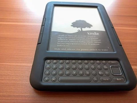 Vintage Amazon Kindle third generation e-reader with physical QWERTY keyboard Stock Photos