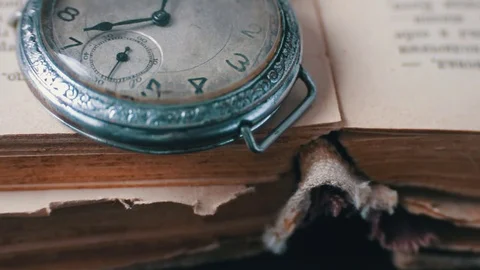 Vintage Antique pocket watch on the background of old books Stock Footage