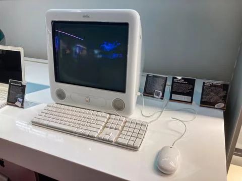 Vintage Apple computer and peripheral equipment on a minimalistic white desk, Stock Photos