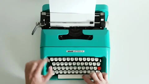 Vintage appliances, using a  portable mechanical typewriter Stock Footage 152855484