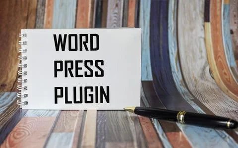 On a vintage background, a white notebook with the text WORD PRESS PLUGIN Stock Photos