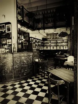 Vintage bar interior featuring checkered floor and graffiti walls Stock Photos
