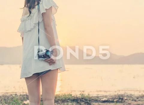 Vintage of beautiful women photography standing hand holding retro camera wit Stock Photos