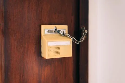 Vintage beige door intercom system with an attached metal security chain lo.. Stock Photos
