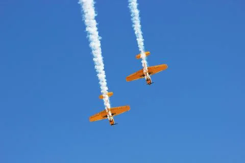 Vintage biplane does loop stunt with smoke trails. airplane air Stock Photos