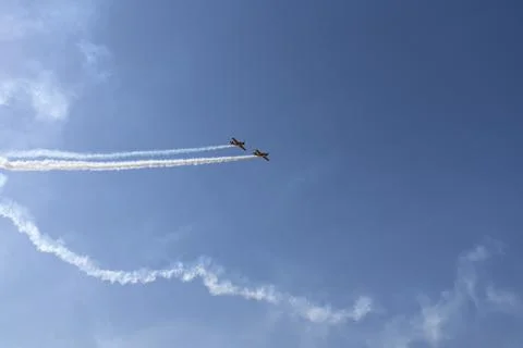 Vintage biplane does loop stunt with smoke trails. airplane air show Stock Photos